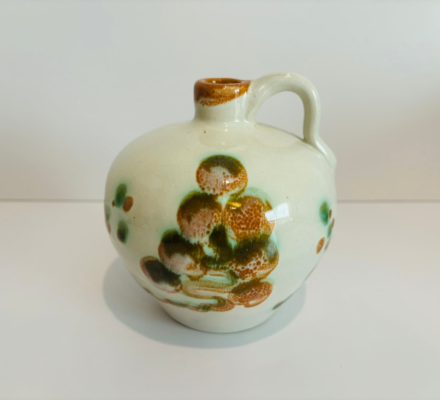 White green and brown pottery jug 5 x 5